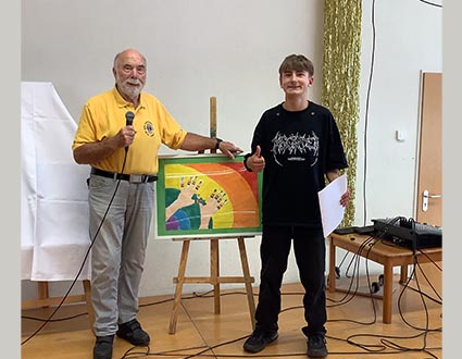 Malwettbewerb Schüler mit Kunstwerk - Herr Book vom Lions Club verkündete die Gewinnerinnen und Gewinner - Bild mit Schüler